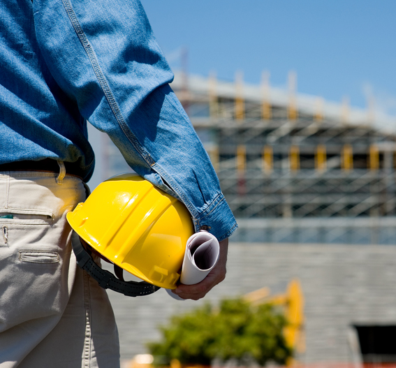 Construction professional holding hard hat